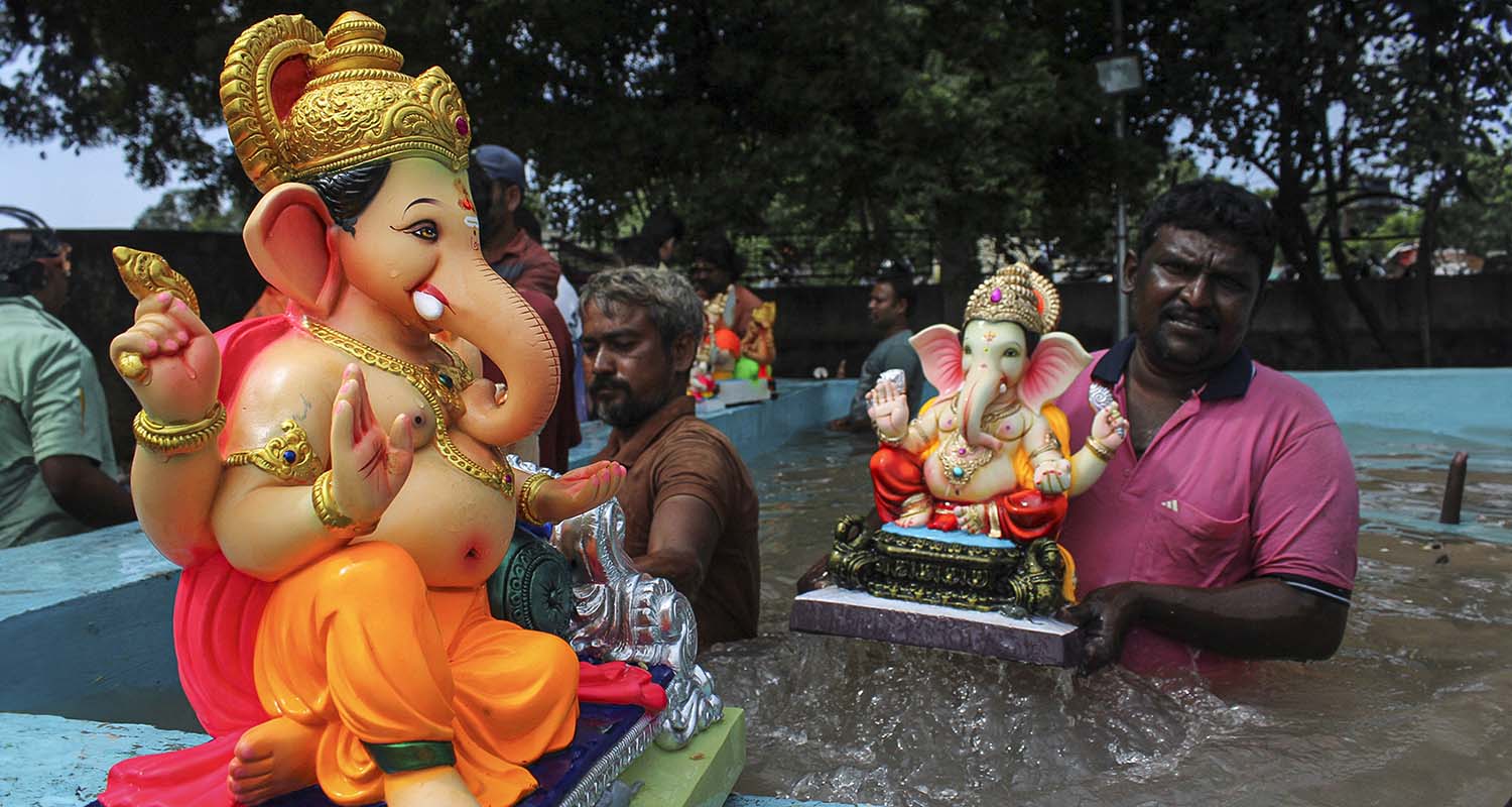People immerse idols of Lord Ganesha in an artificial tank as part of the Ganesh Chaturthi festival celebrations, in Solapur, on Saturday.