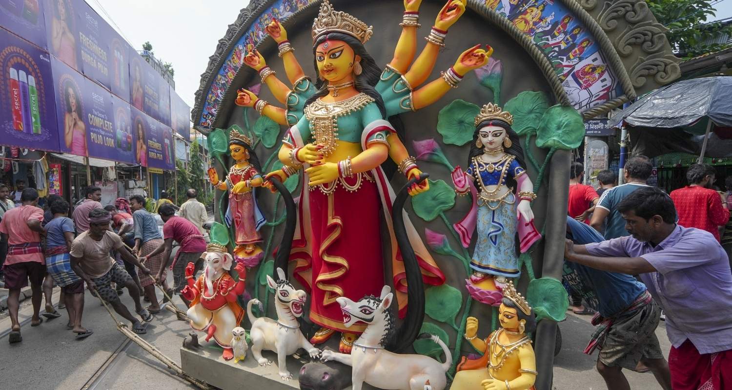 An artisan works on the idol of Goddess Durga on the occasion of Mahalaya marking the beginning of Durga Puja, in Nadia, Sunday.