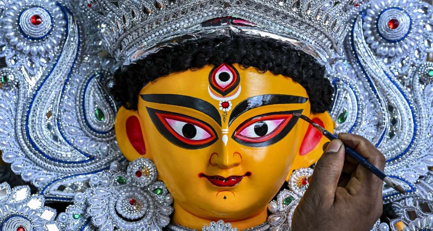 An artisan works on the idol of Goddess Durga on the occasion of Mahalaya marking the beginning of Durga Puja, in Nadia, Sunday.