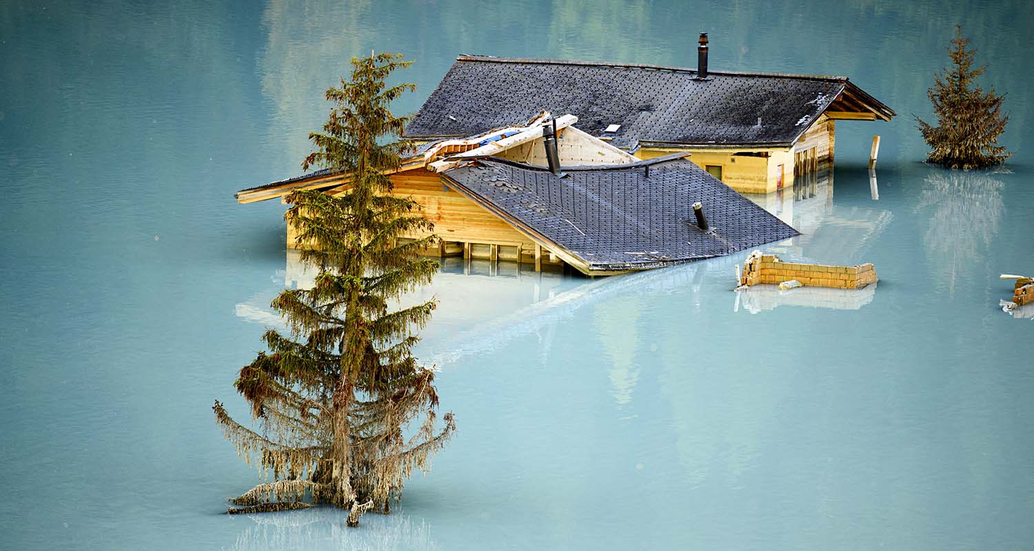 Destroyed and flooded houses are pictured during the groundbreaking ceremony of reconstruction of the devastated village of Blatten, Switzerland, on Friday,