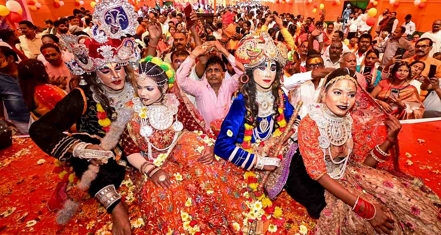 Artists dressed as Lord Krishna and Radha perform during a 'Holi Milan Samaroh' as part of the 'Holi' festival celebrations, in Patna, Bihar, on Tuesday.