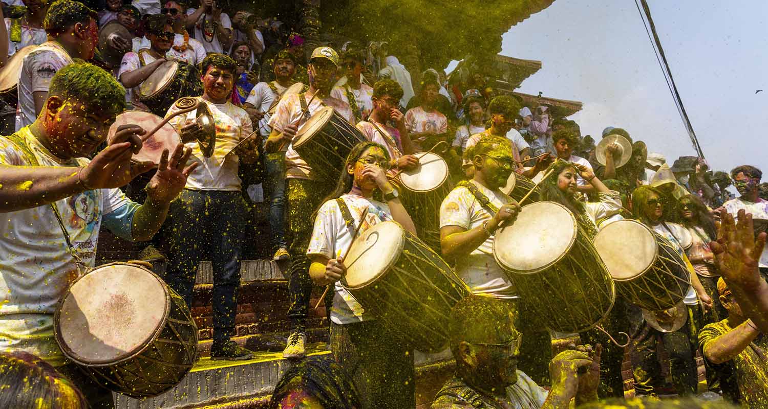 Prayagraj: Members of Kinnar Akhara play with colours and flower petals during Holi celebration, in Prayagraj, Thursday
