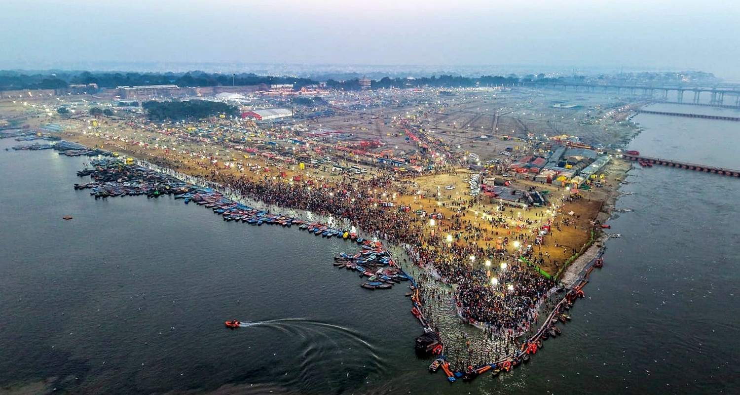 People take a holy dip at Sangam on the occasion of Maha Shivaratri, in Prayagraj.
