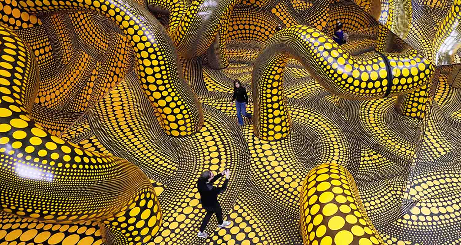 People walk through the artwork 'Infinity Mirrored Room' during a preview of the new major exhibition of legendary Japanese artist Yayoi Kusama at the Museum Ludwig in Cologne, on Thursday. People walk through the artwork 'Infinity Mirrored Room' during a preview of the new major exhibition of legendary Japanese artist Yayoi Kusama at the Museum Ludwig in Cologne, on Thursday.