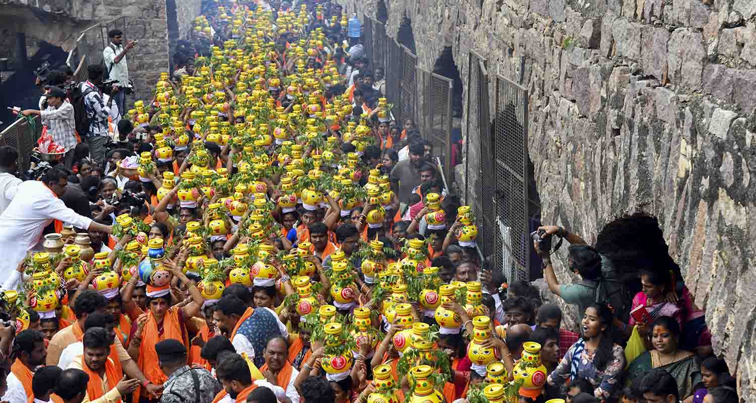 Hyderabad: Women carry Bonam pots during the Ashada Masam Bonalu celebrations at Golconda Fort, in Hyderabad, Telangana.
