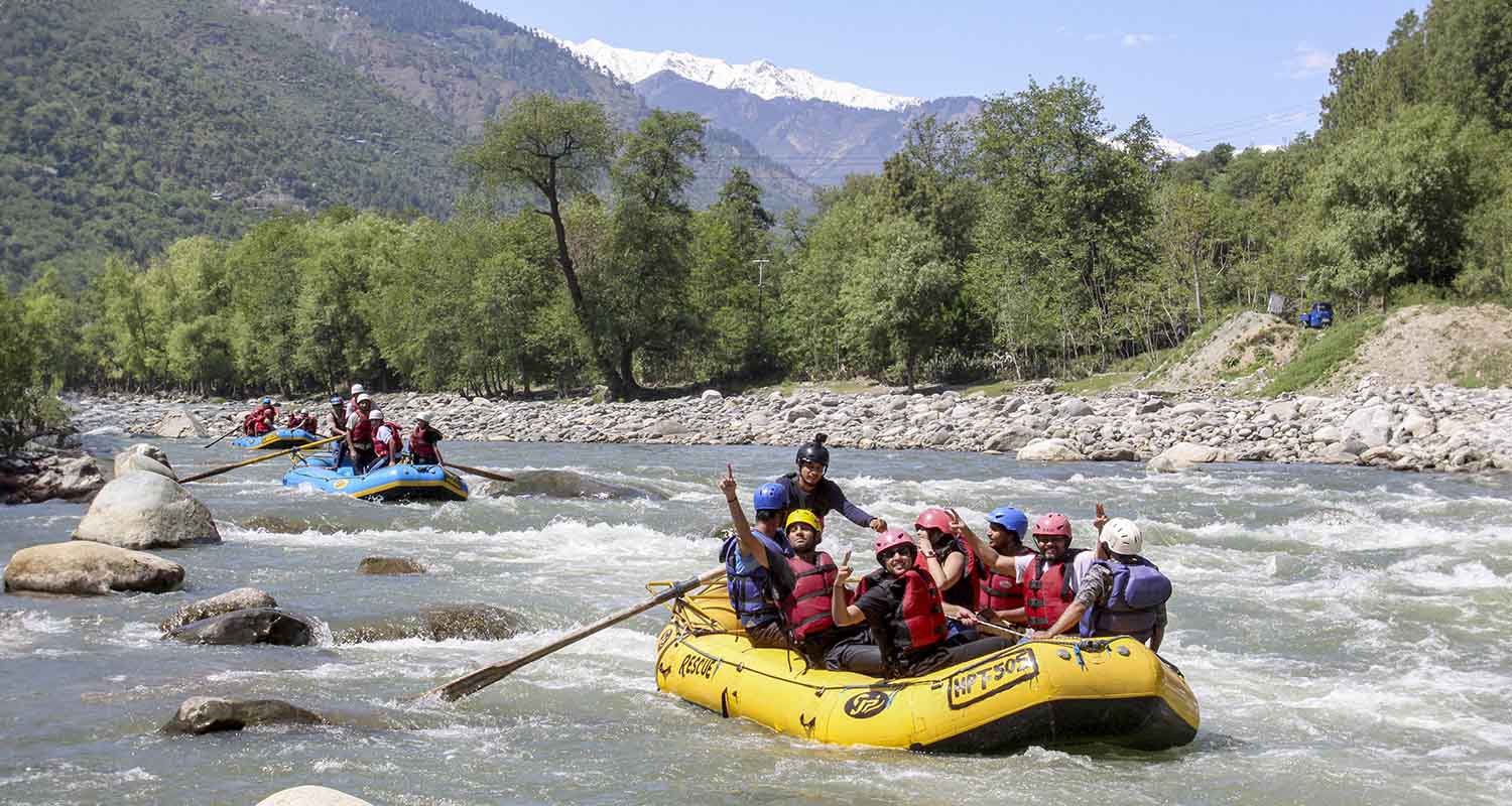 Tourists participate in river rafting in the Beas River near Manali, in Kullu district of Himachal Pradesh, on Monday.