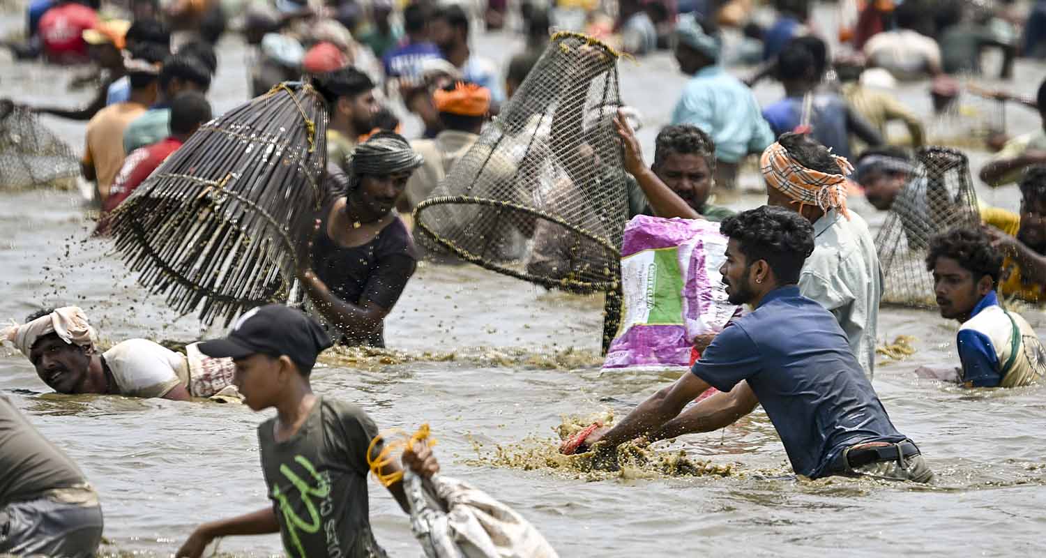 Students cross a bamboo bridge over a river in the Hahim area, Kamrup district, Assam, on Thursday.