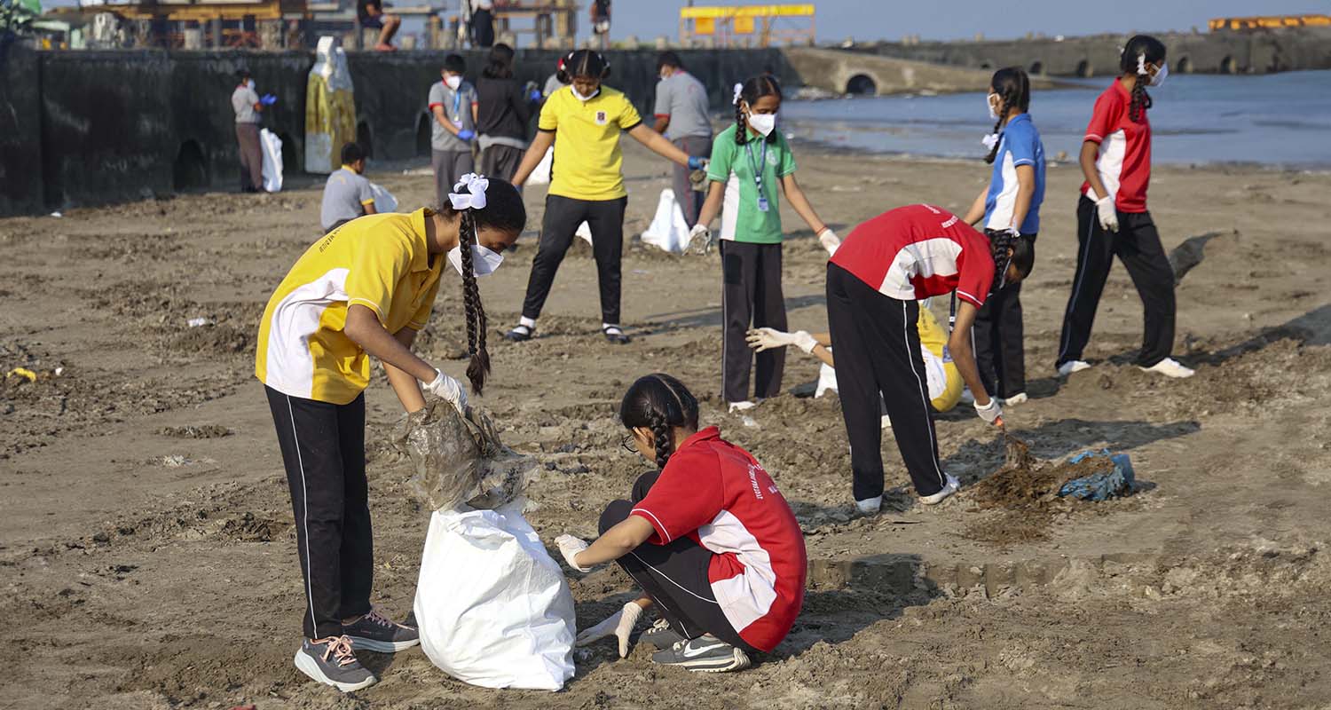 Students take part in a cleanliness drive at Juhu beach, in Mumbai, on Saturday.