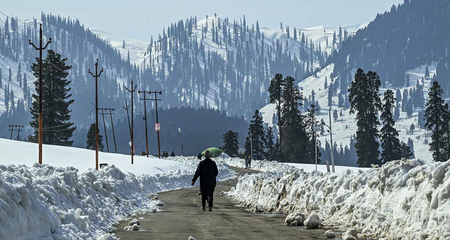 A man walks through a snow-covered area, at Doodhpathri area in Budgam, Tuesday, Feb. 17, 2026. 14 tourist destinations in the Union Territory, which were closed in April last year following the Pahalgam terror attack, were opened.